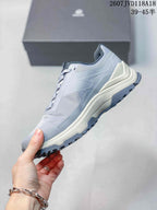 Side profile of the gray KAILAS sneaker showing the mesh panels, protective overlays, raised midsole, and lugged outsole.