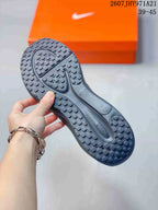 Close-up of the black sneaker outsole showing a patterned rubber tread and traction lugs.