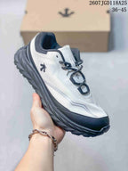 Angled side view of the white and black low-top sneaker with its rugged outsole.