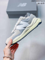 Side profile showing the layered upper, New Balance logo and thick midsole.