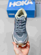 Front view of the gray lace-up running shoe showing the rounded toe, padded collar, and layered upper.