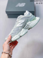 Side profile of the New Balance 9060 sneaker showing layered panels, mesh sections and a sculpted thick midsole.