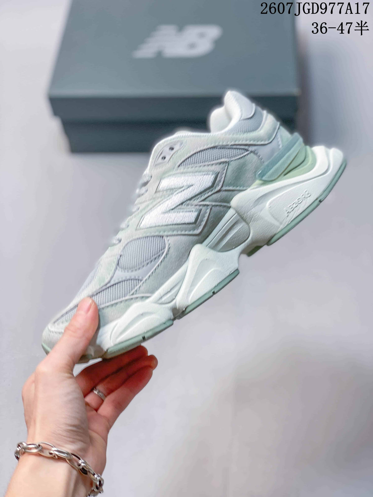 Side profile of the New Balance 9060 sneaker showing layered panels, mesh sections and a sculpted thick midsole.