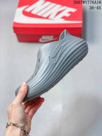 Side profile highlighting the gray one-piece shape, raised side logo, and layered ridges.