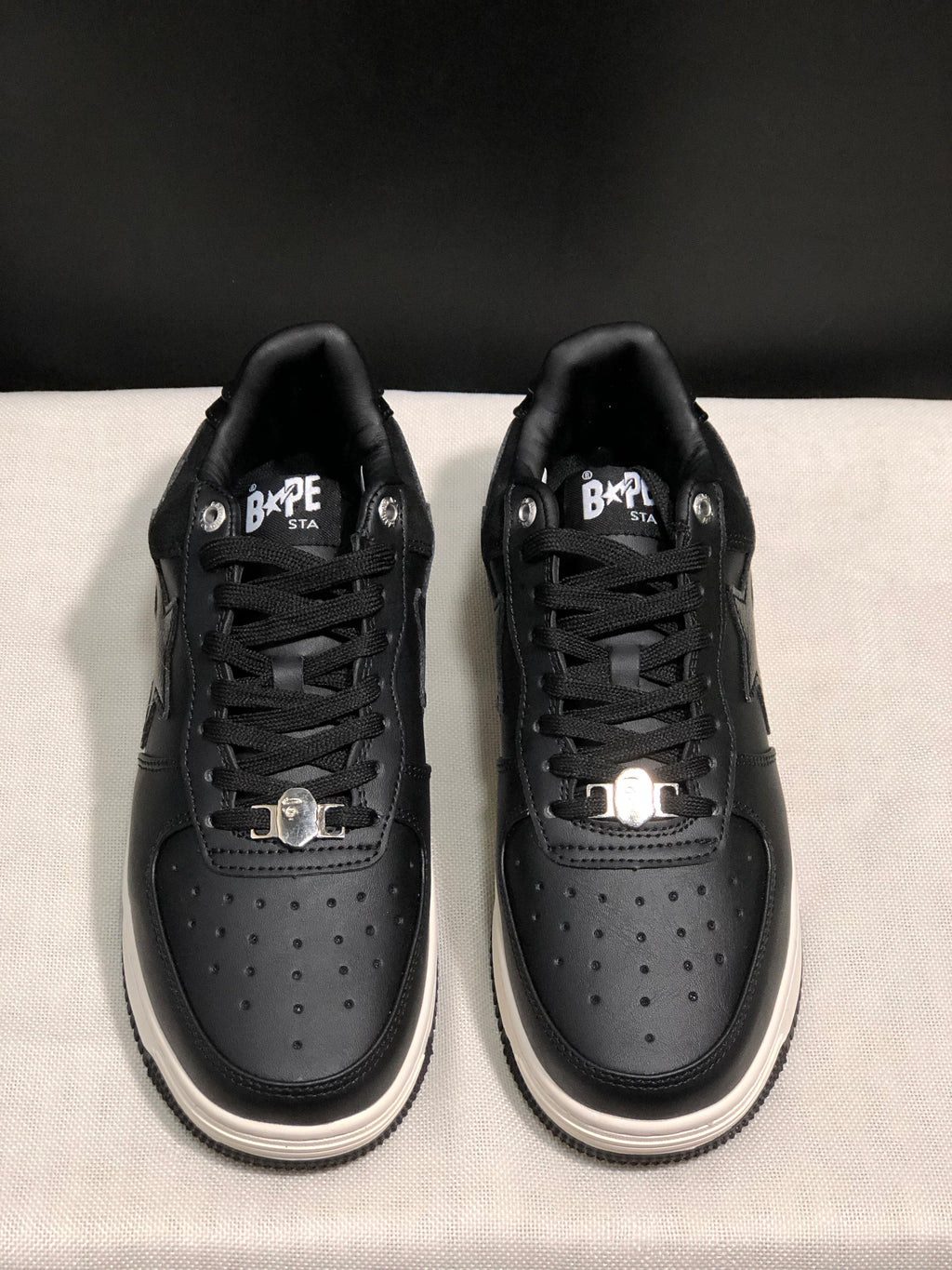Front view showing the perforated toe boxes, lace-up construction, and metallic lace accessories.