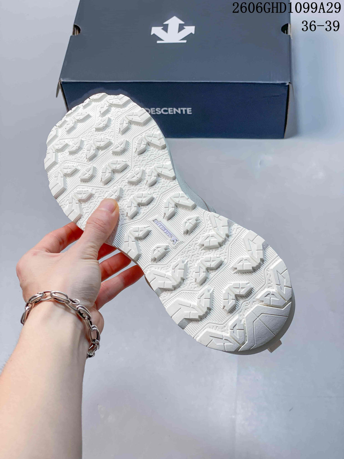 Close-up of the patterned outsole on the off-white DESCENTE sneaker