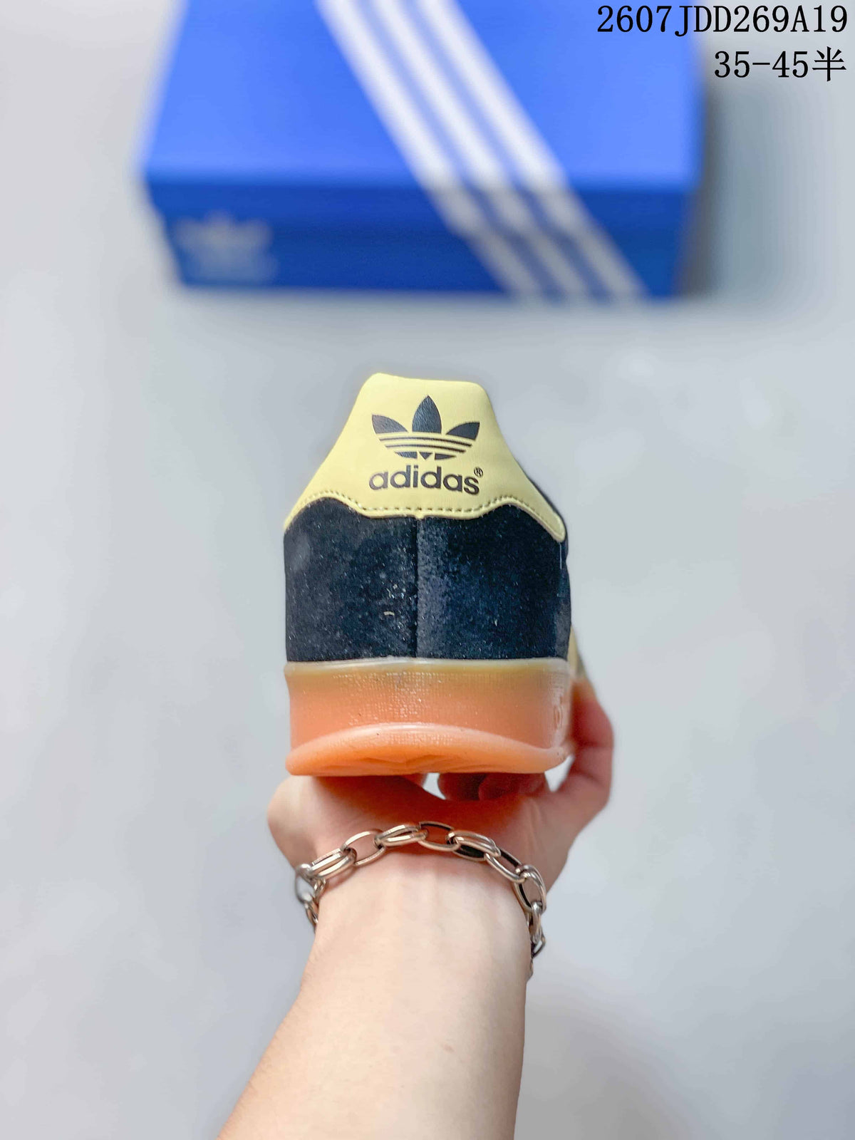 Rear view of the sneaker showing the Adidas trefoil heel detail and gum-colored heel section.