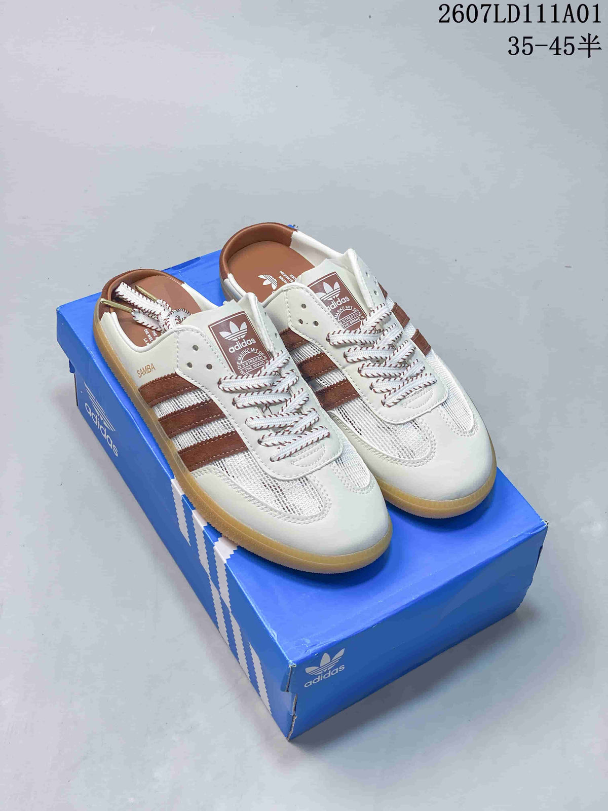 White mule sneakers with brown side stripes, mesh panels, patterned laces, and gum-colored outsoles.