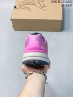 Rear view of the pink hiking shoe showing the padded heel structure, white midsole and dark outsole.