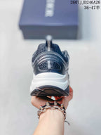 Rear view of the sneaker showing the padded heel, pull tabs, layered panels, and contrasting sole.