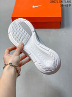 Underside of a white running shoe showing the outsole tread
