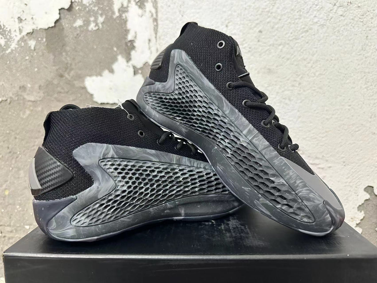 Pair of black and grey Adidas high-top basketball shoes shown from the side.