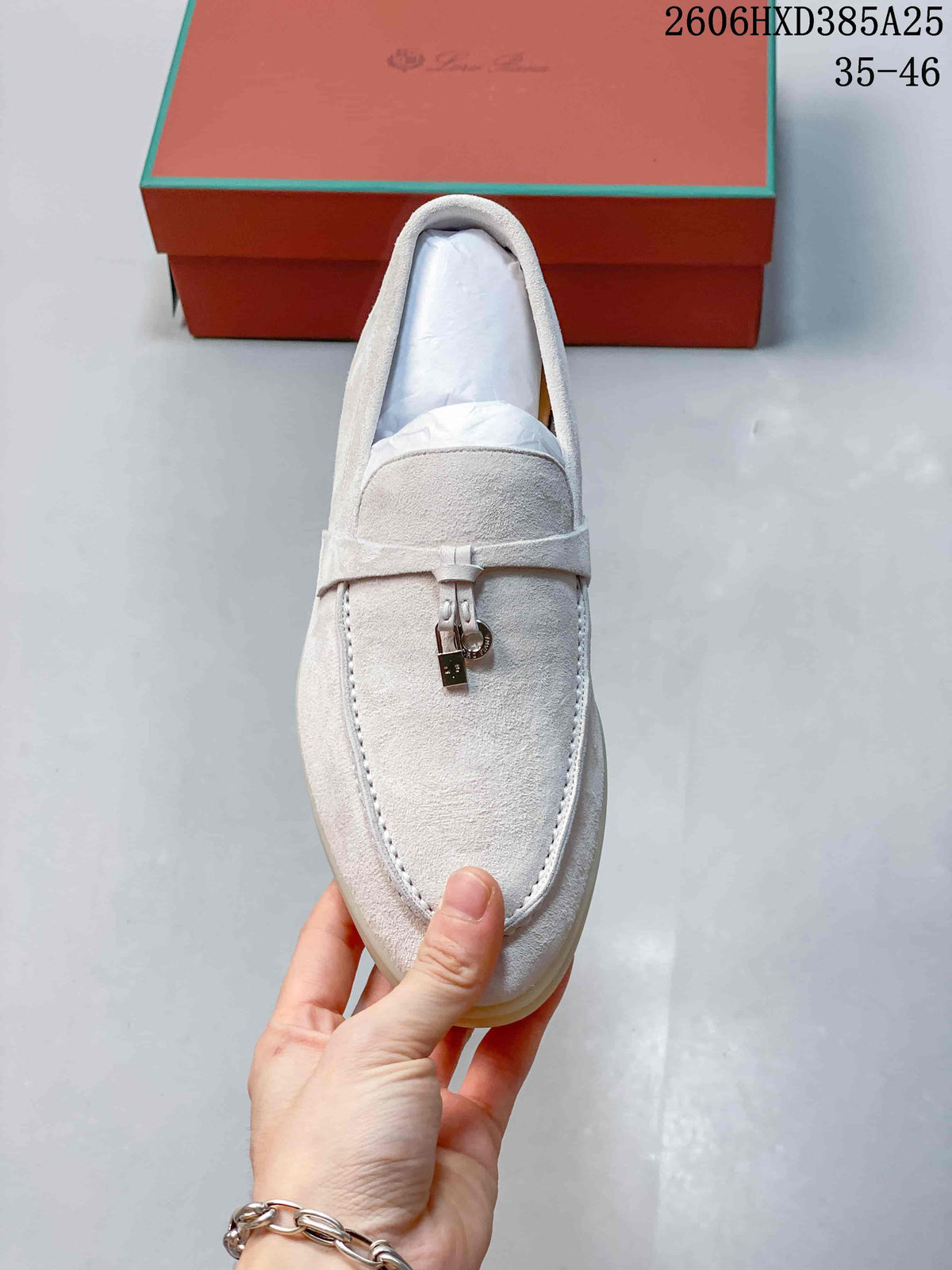 Top view of the loafer showing the moc-toe stitching and metal ornament