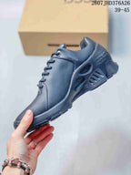 Side view of the black ECCO BIOM sneaker showing the lace-up upper, perforated side panel, heel openings, and textured sole.