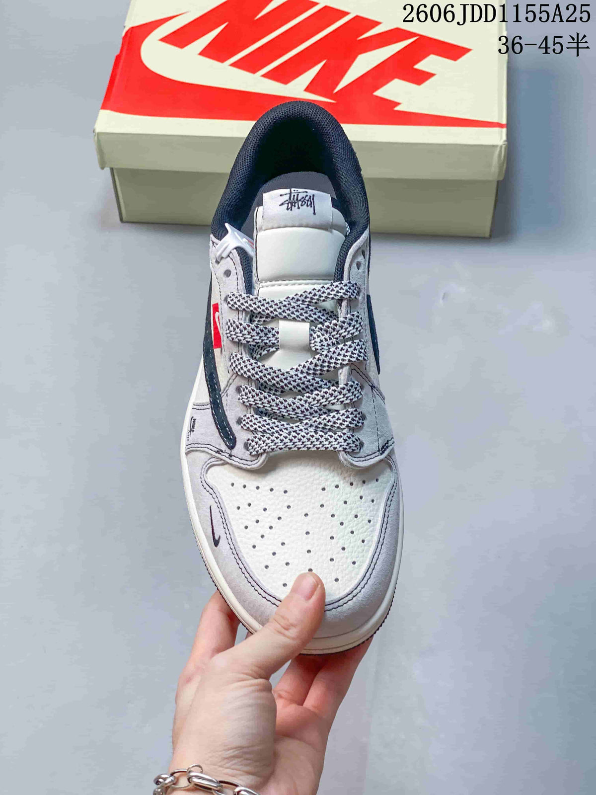 Top view showing the perforated white toe box, patterned laces, padded tongue, and navy collar lining.