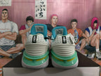 Rear view of white Nike basketball shoes with turquoise collars and green and yellow sole accents.