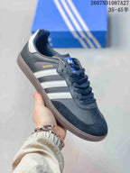 Angled side view showing Samba branding, white three-stripe panels, black upper and gum-colored outsole.