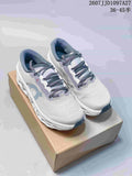 Pair of white and gray On sneakers displayed on a box, showing the lace-up design and open pod-style sole.