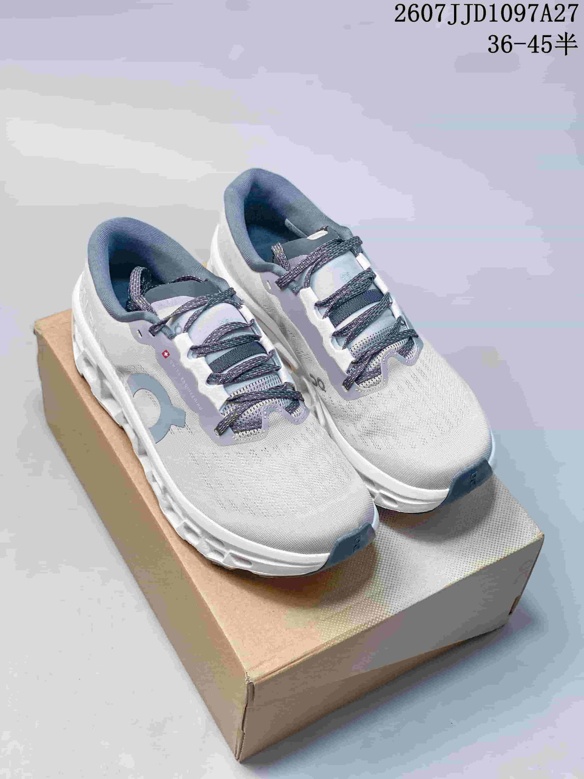 Pair of white and gray On sneakers displayed on a box, showing the lace-up design and open pod-style sole.