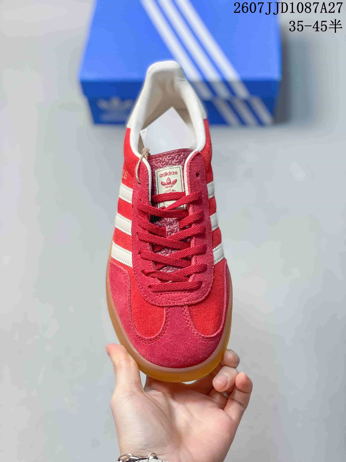Top view showing red laces, white collar, tongue label and rounded toe.