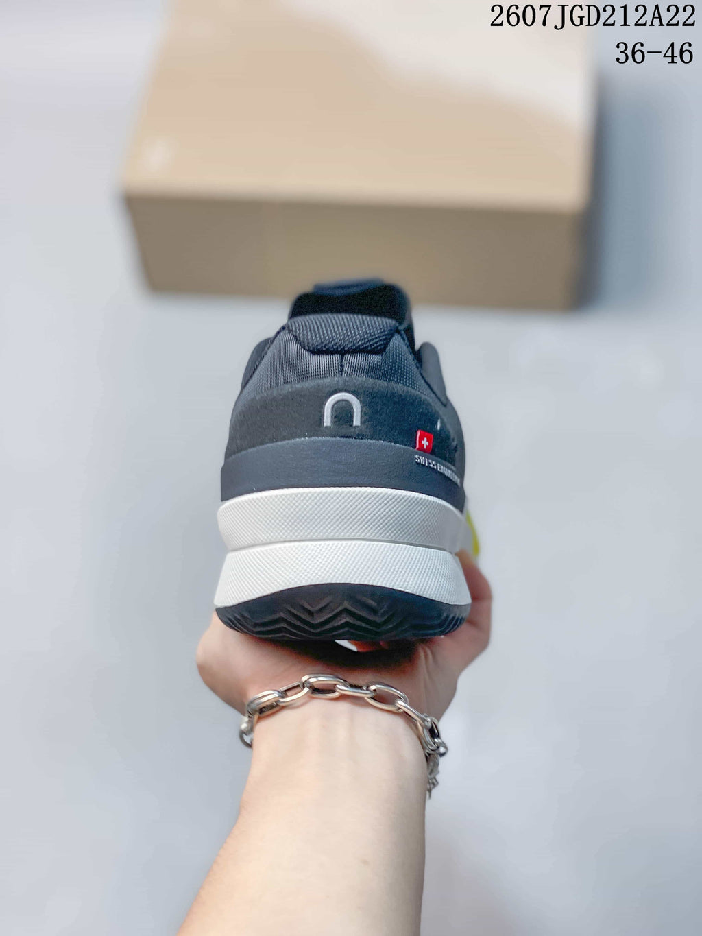 Rear view showing the padded heel, layered white midsole, dark outsole, and On branding.