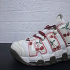 Close-up of burgundy laces, white lace loops, and printed panels