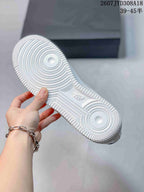 View of the white textured outsole with circular traction patterns and raised branding details.