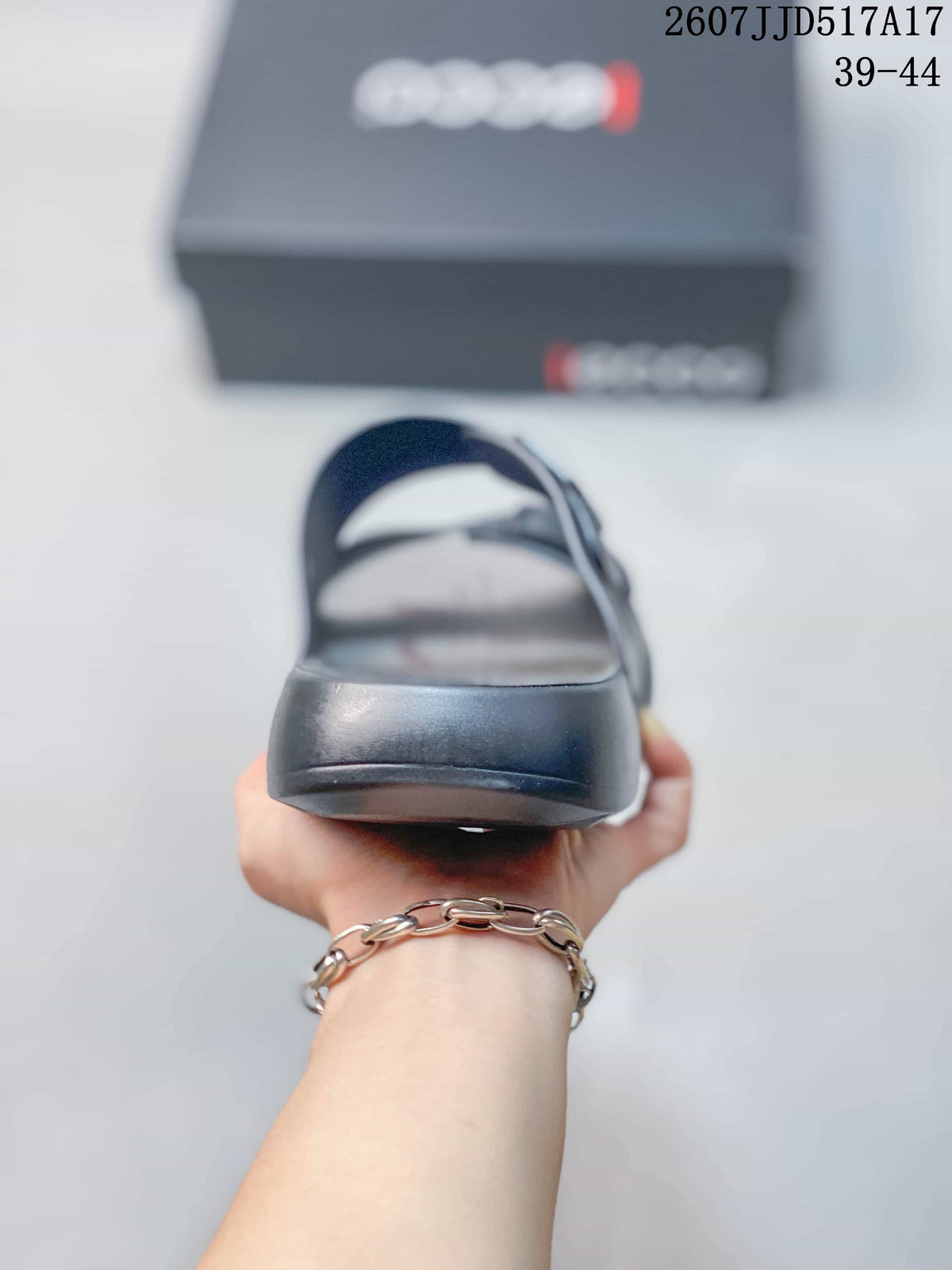 Front view of the dark gray open-toe sandal showing the rounded toe, footbed, and layered sole.
