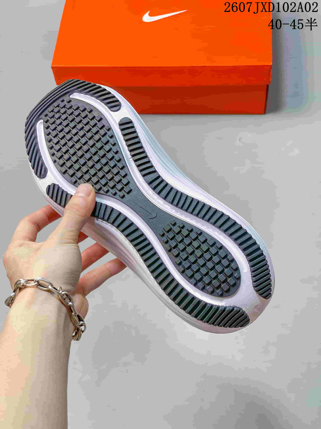View of the black patterned outsole and white midsole