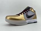 Low side angle showing the gold toe, striped side panel, and white outsole.