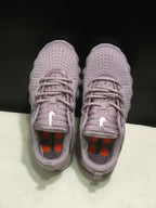 Top view showing the lace-up design, padded tongues and orange insole accents.