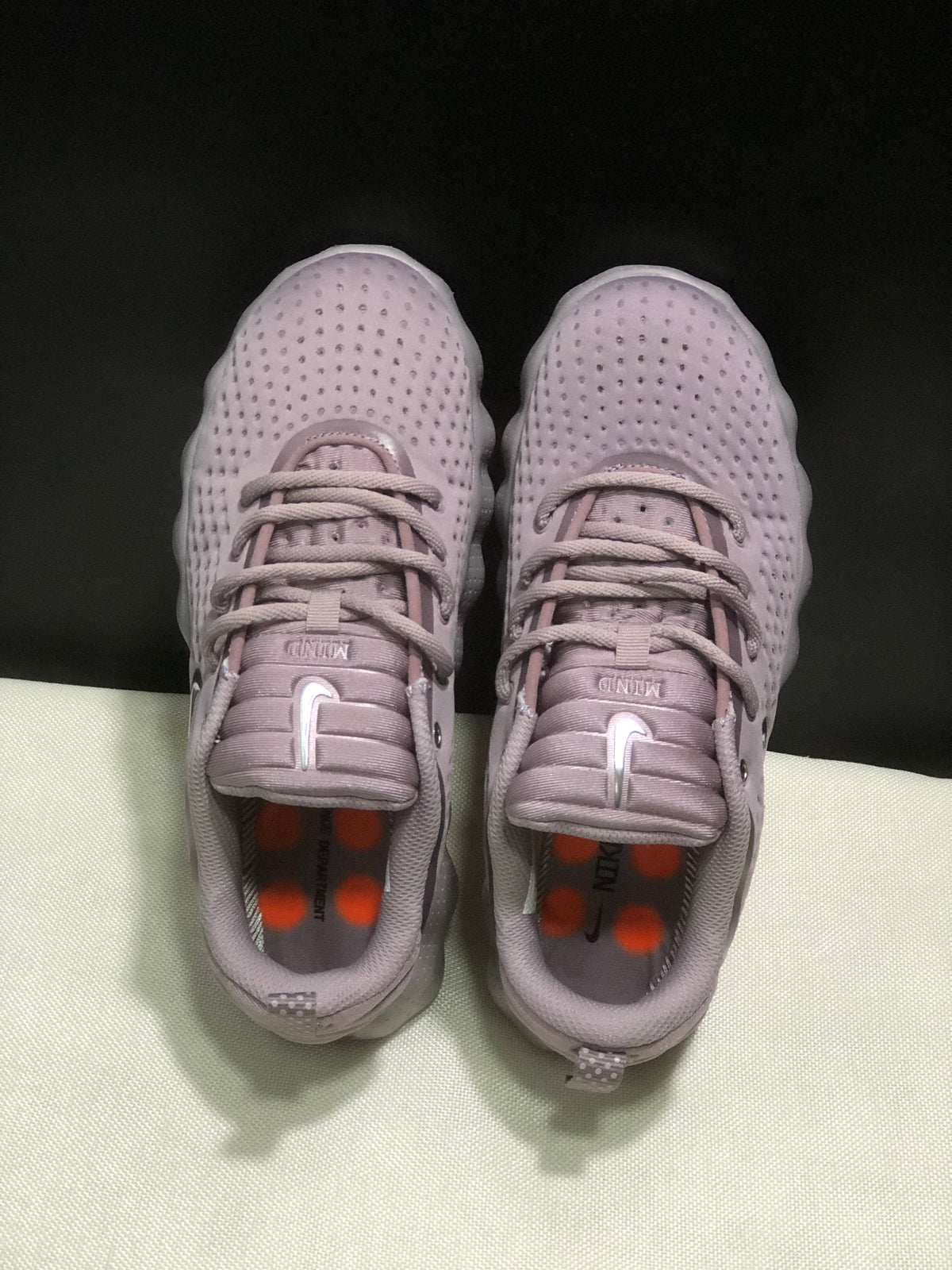Top view showing the lace-up design, padded tongues and orange insole accents.