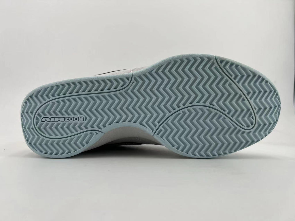 Underside of the sneaker showing pale blue herringbone-style tread