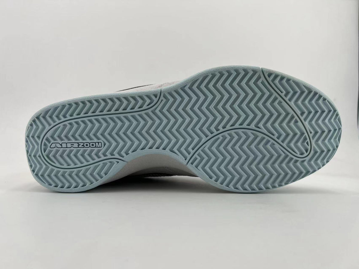 Underside of the sneaker showing pale blue herringbone-style tread