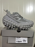 Grey Balenciaga Defender sneaker displayed on its box, with a label showing the style code, color and EU size 41.