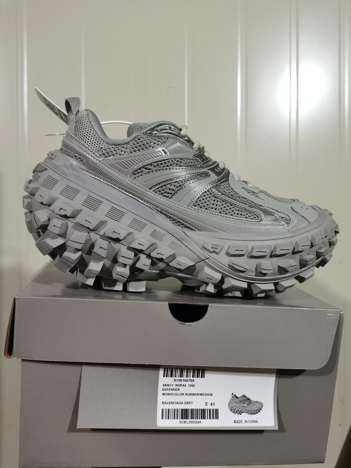 Grey Balenciaga Defender sneaker displayed on its box, with a label showing the style code, color and EU size 41.