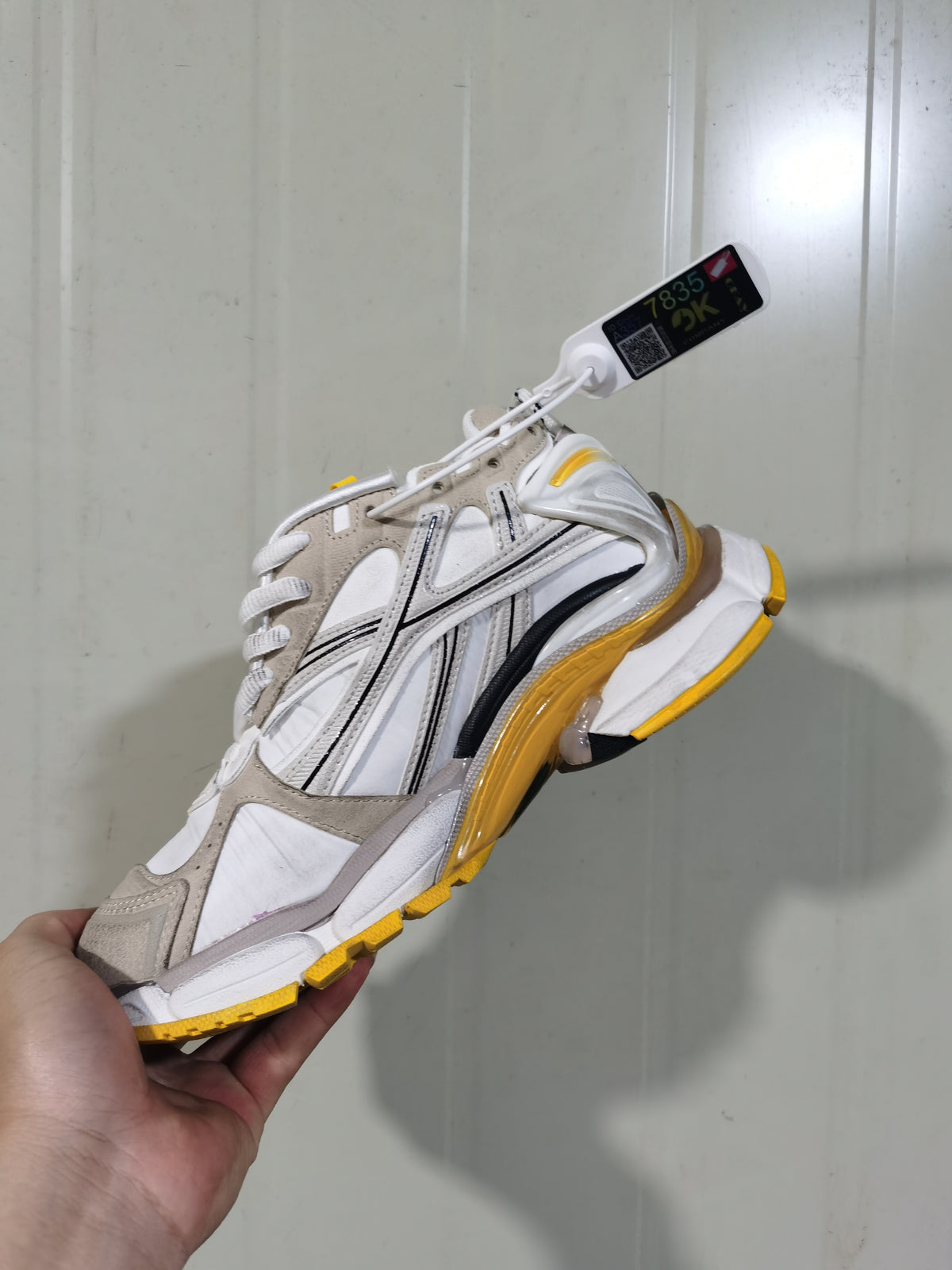 Side view of the white and grey Puma Runner 9170 sneaker, showing layered panels, black detailing and yellow outsole accents.