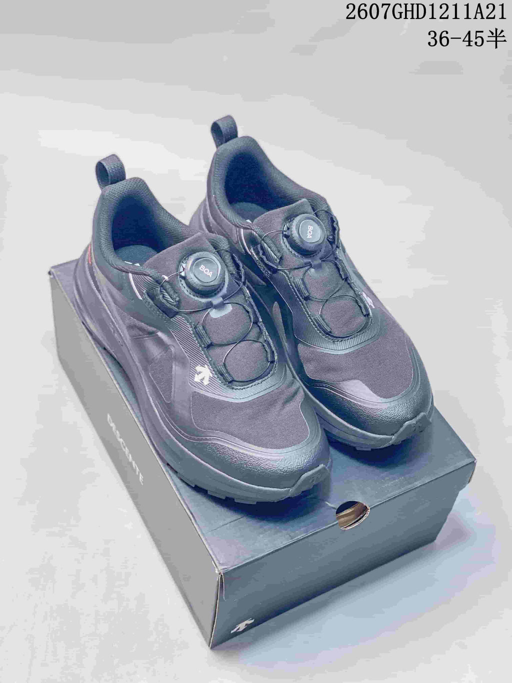 Pair of black DESCENTE LAVITATE WIRE 3.0 sneakers shown from above on a shoebox, with BOA dials and style code 2607GHD1211A21 visible.