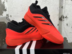 Pair of red and black Adidas Dame 9 basketball shoes shown at an angle