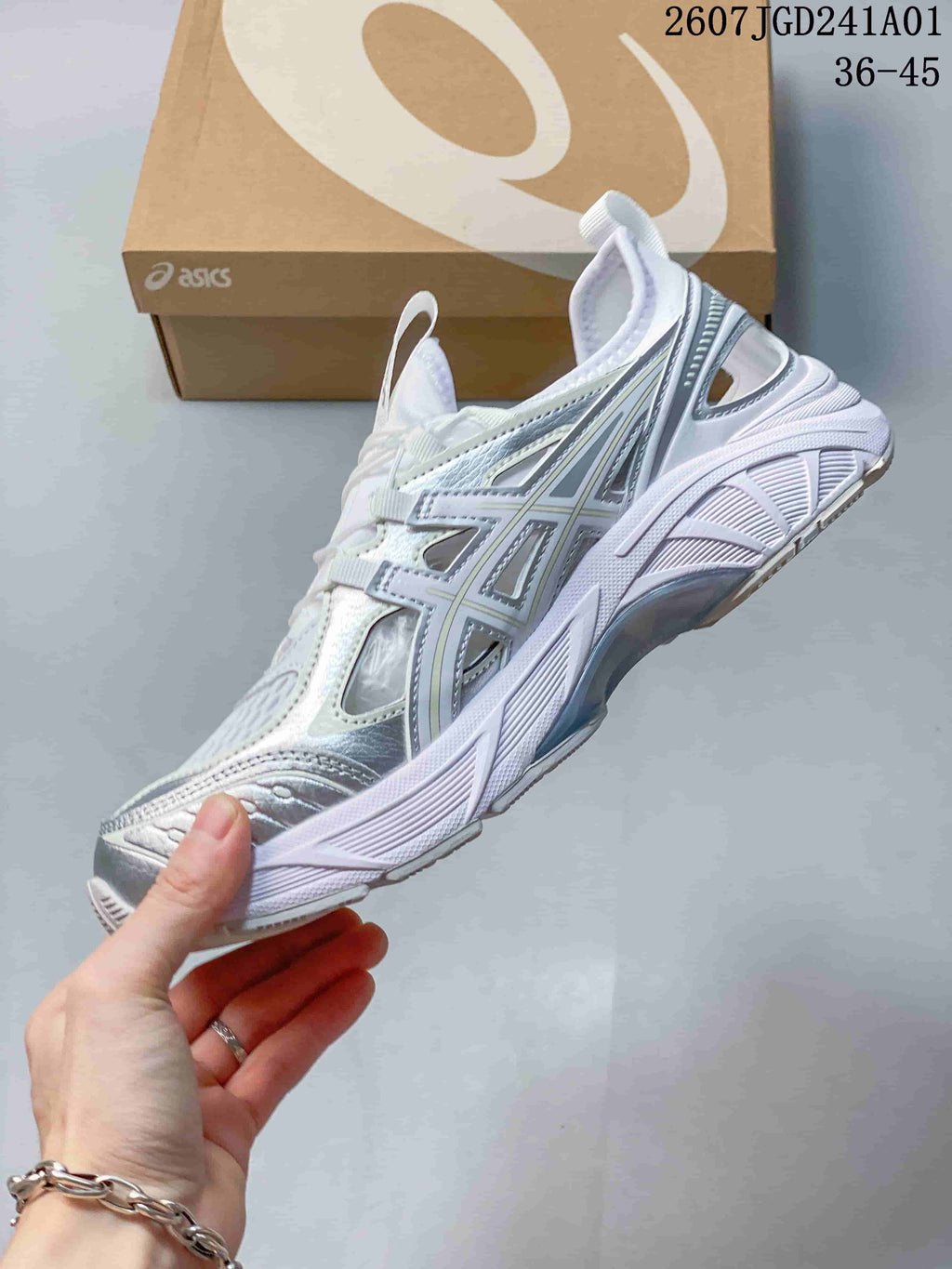 Side view of a white and silver ASICS GT-2160 Breeze sneaker with open side details.