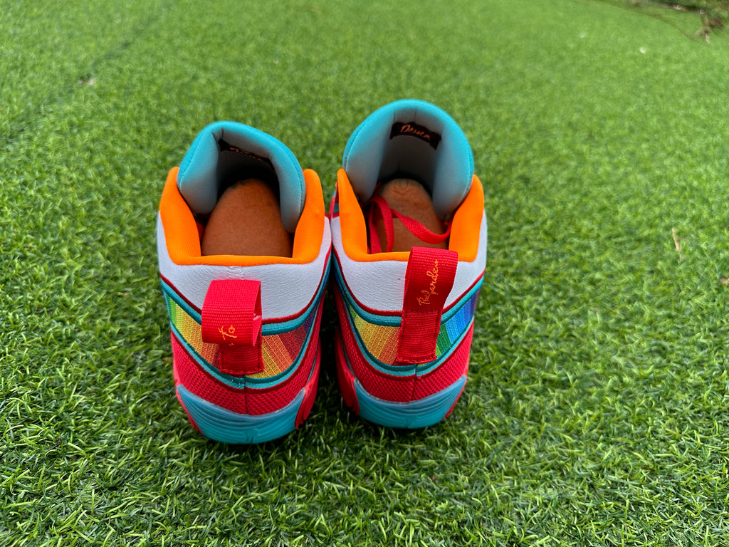 Rear view showing colorful heel panels and orange collars