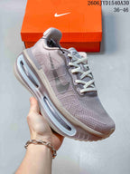 Angled side view of a mauve-gray Nike sneaker with white laces and a sculpted sole