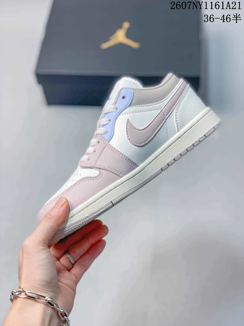 Side view showing the low-top profile, white base, pink overlays and light blue eyelet panel.