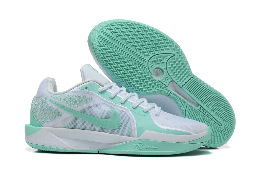 Side view of white and mint-green Nike Sabrina basketball shoes with outsole visible
