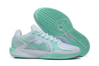 Side view of white and mint-green Nike Sabrina basketball shoes with outsole visible