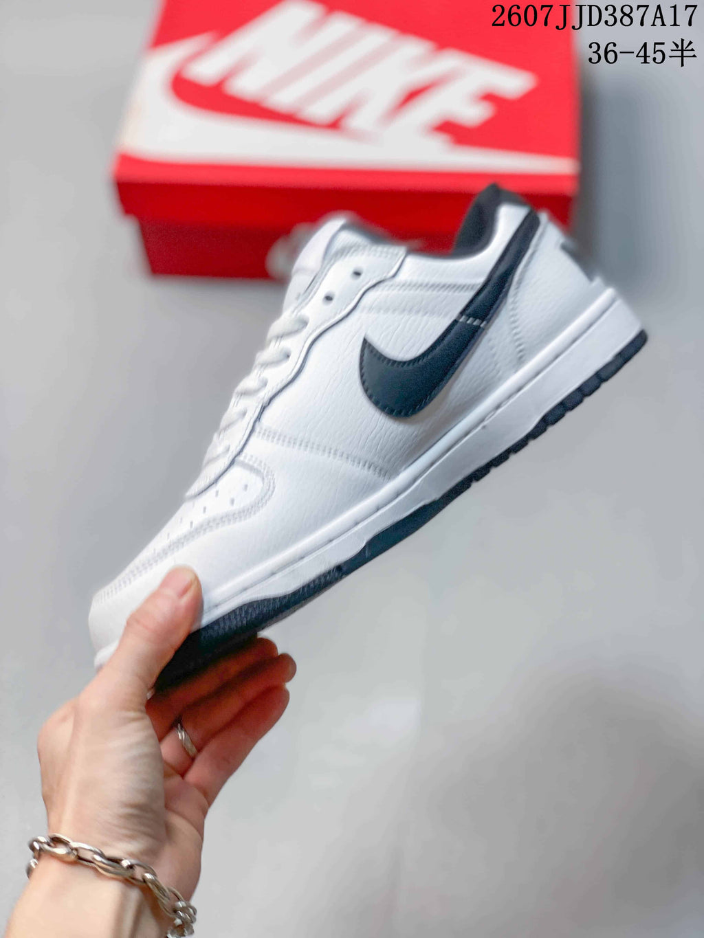 Side view showing the white low-top profile, black Swoosh and layered sole.