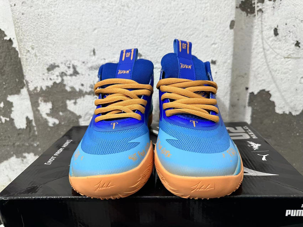 Front view of blue and light blue Puma Melo basketball shoes with yellow-orange laces and sole accents.