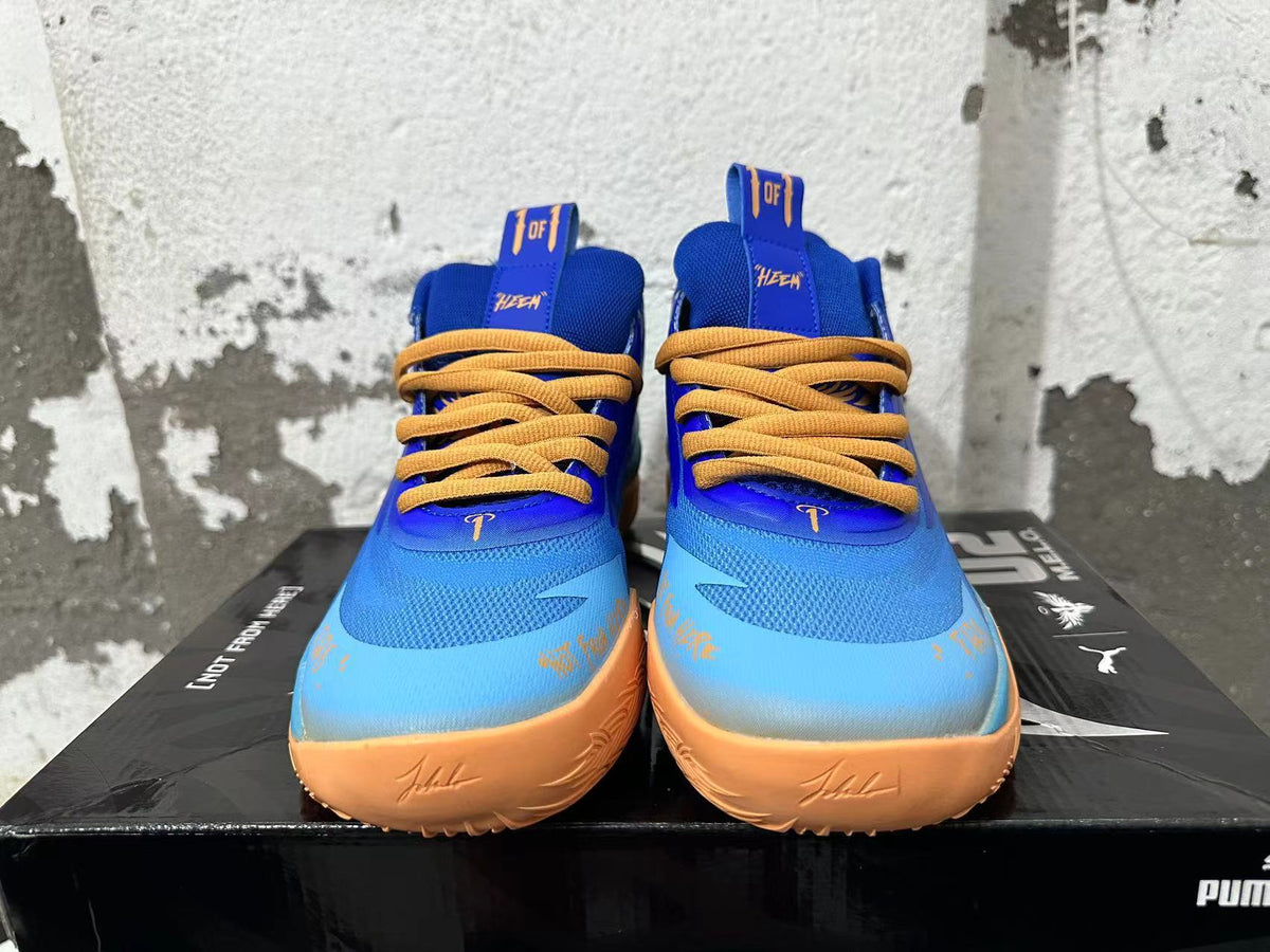 Front view of blue and light blue Puma Melo basketball shoes with yellow-orange laces and sole accents.
