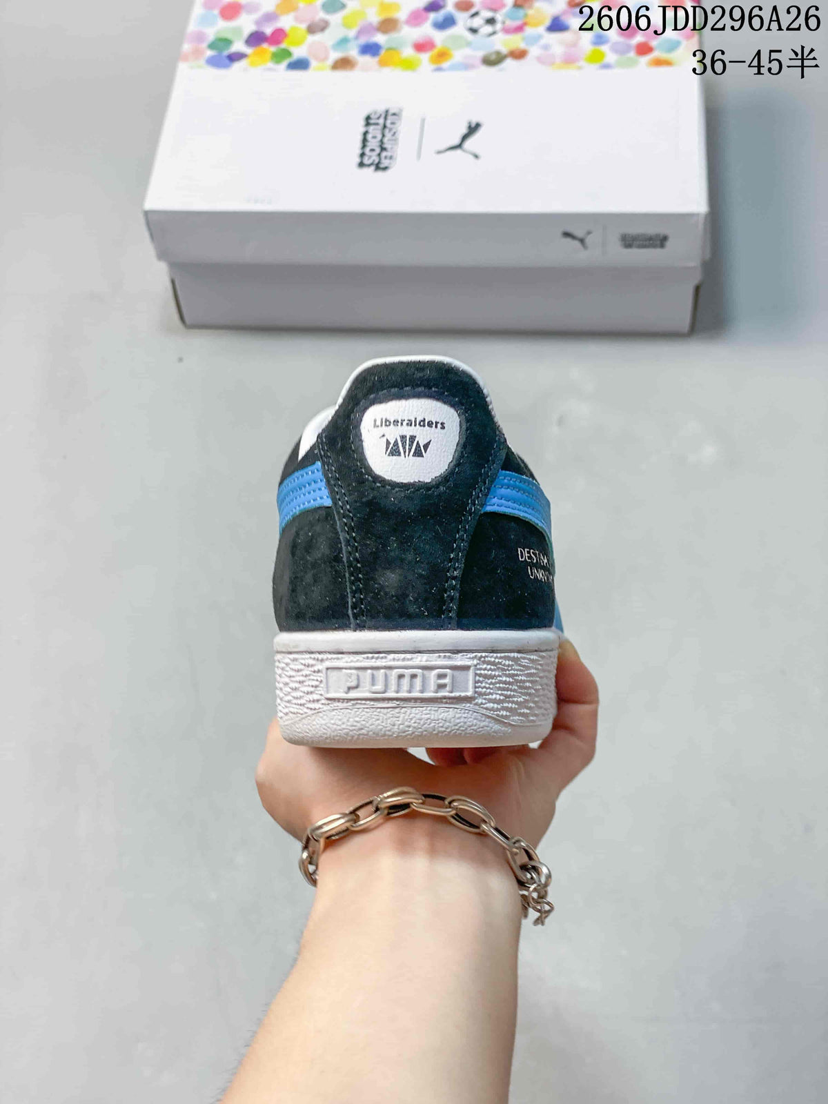 Rear view showing the PUMA heel branding, white heel collar, blue side stripes, and branded shoebox.