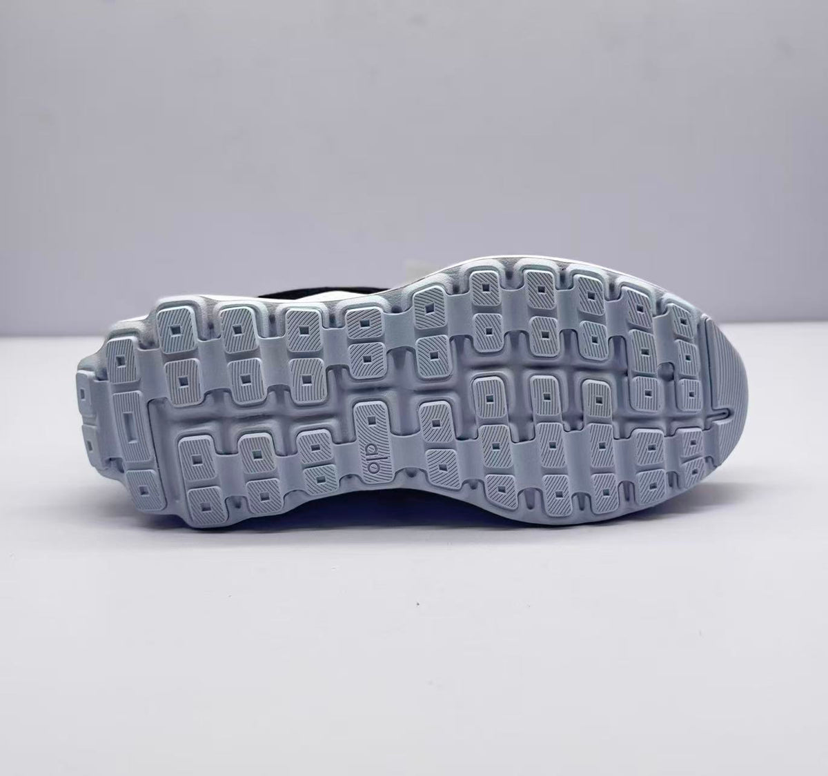 Bottom view showing the patterned rubber outsole with rectangular traction sections.